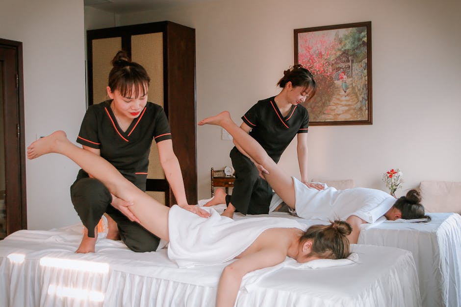 Women receiving therapeutic massages in a serene spa setting, promoting relaxation and wellness