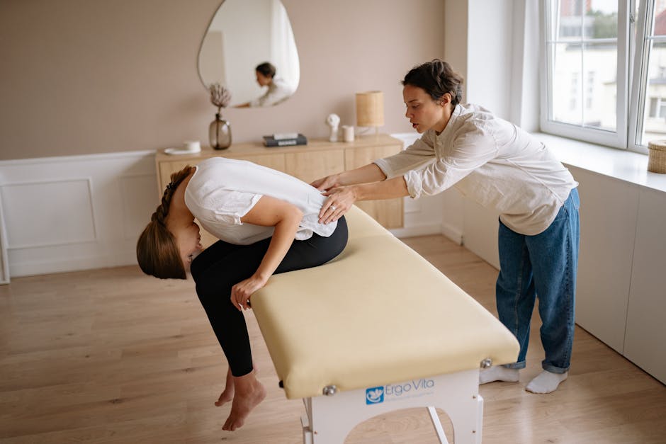 Therapist providing a relaxing back massage treatment to a client indoors on a massage table