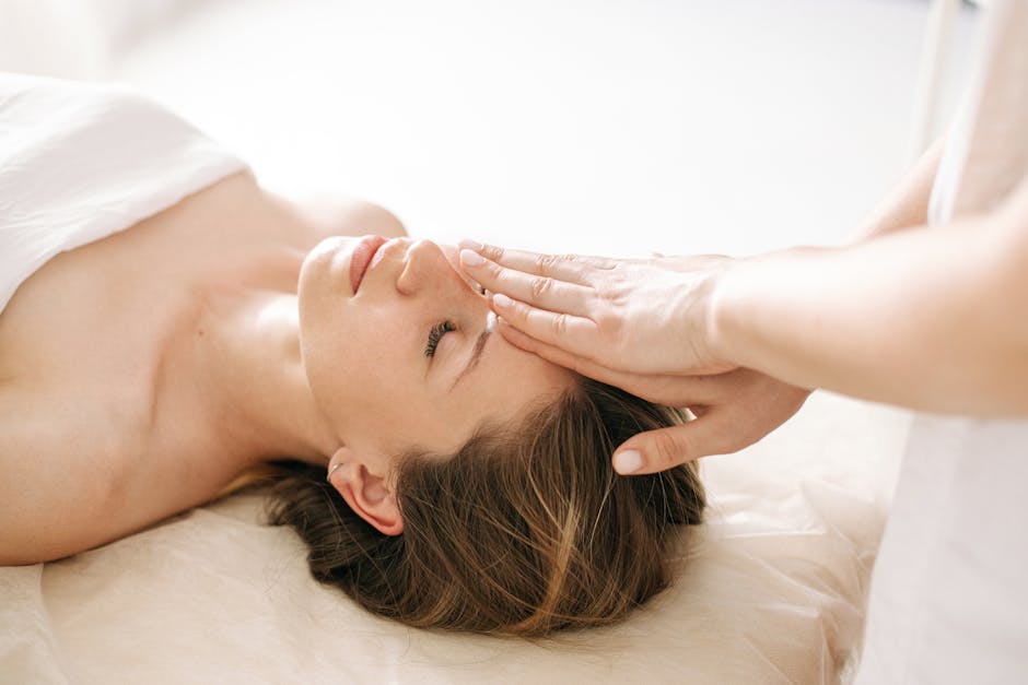 Woman enjoying a peaceful head massage in a serene spa environment
